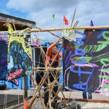 Artist Sarah Kenchington hangs sails by Peter and Rossi at Bridge 8 Hub, during Canal Connections, May 2022. Image_ Julie Howden.